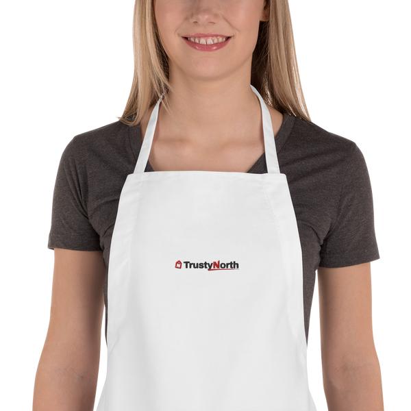 Holiday Baking Crew Apron in white with black and red embroidered TrustyNorth logo